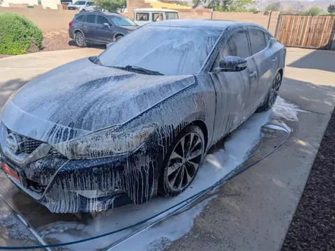 Nissan Maxima covered in foam during a mobile wash