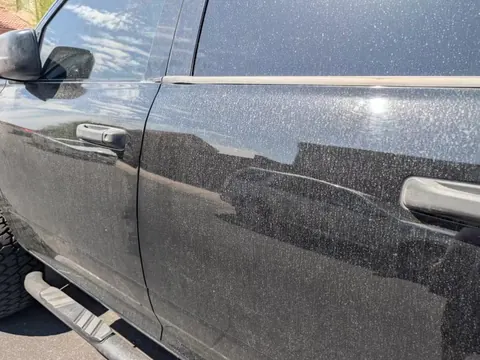 Dust covering the doors of a black Ram pickup