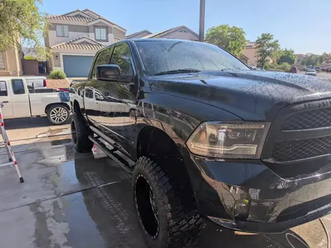 Black lifted Ram 1500 just washed, still wet in the driveway